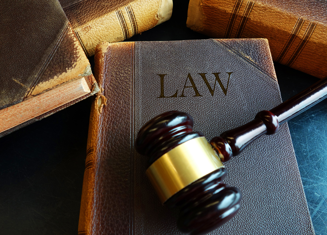 Gavel resting on law book and others.