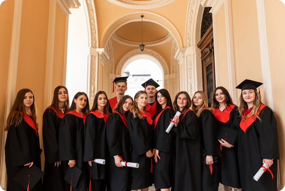 Graduates in caps and gowns holding diplomas.