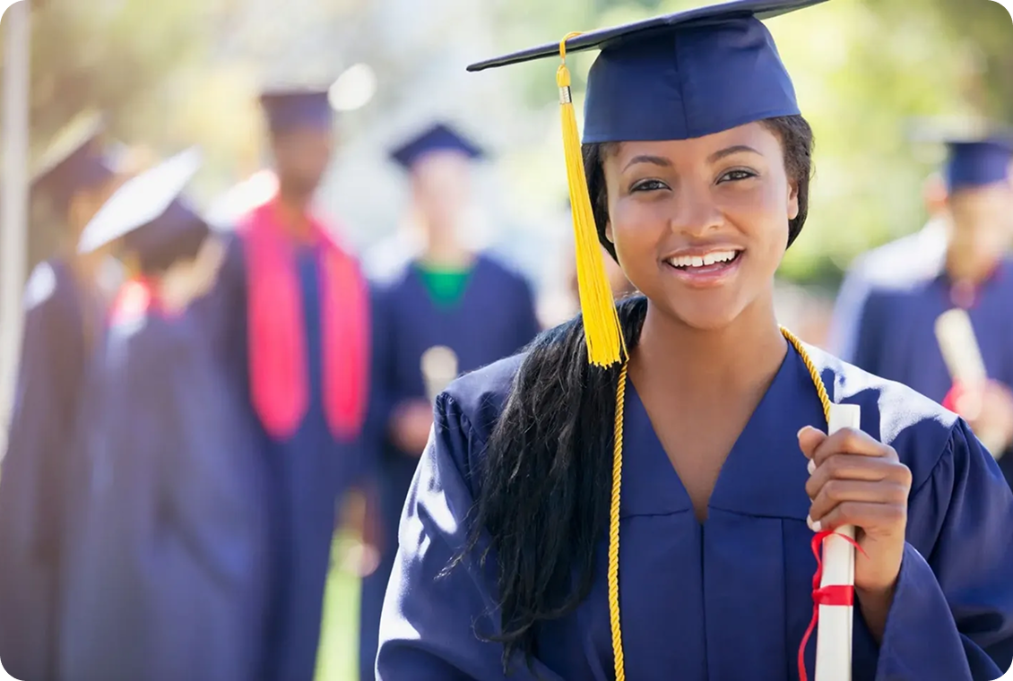 Graduate smiling in cap and gown.